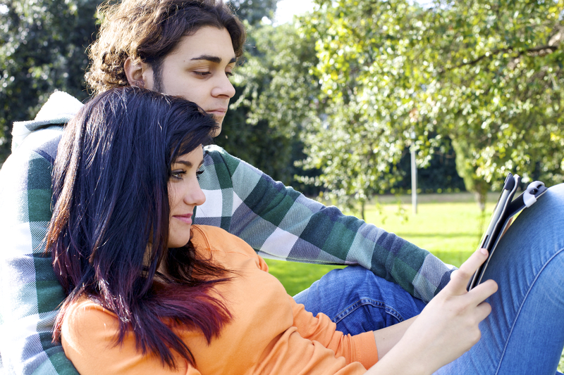 http://www.dreamstime.com/stock-photo-couple-reading-tablet-park-gorgeous-enjoying-technology-wireless-connection-image41261440